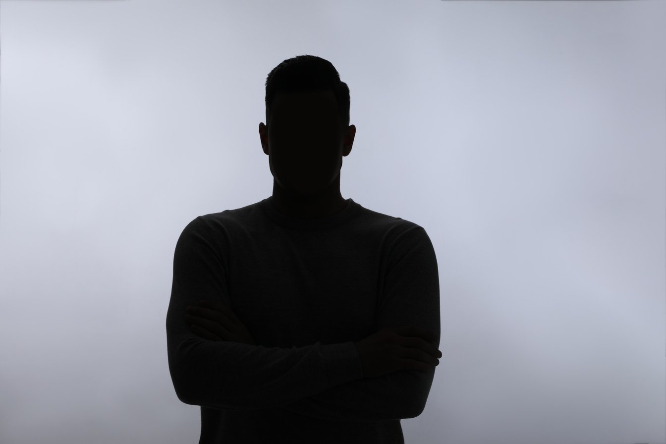 Silhouette of Anonymous Man on White Background